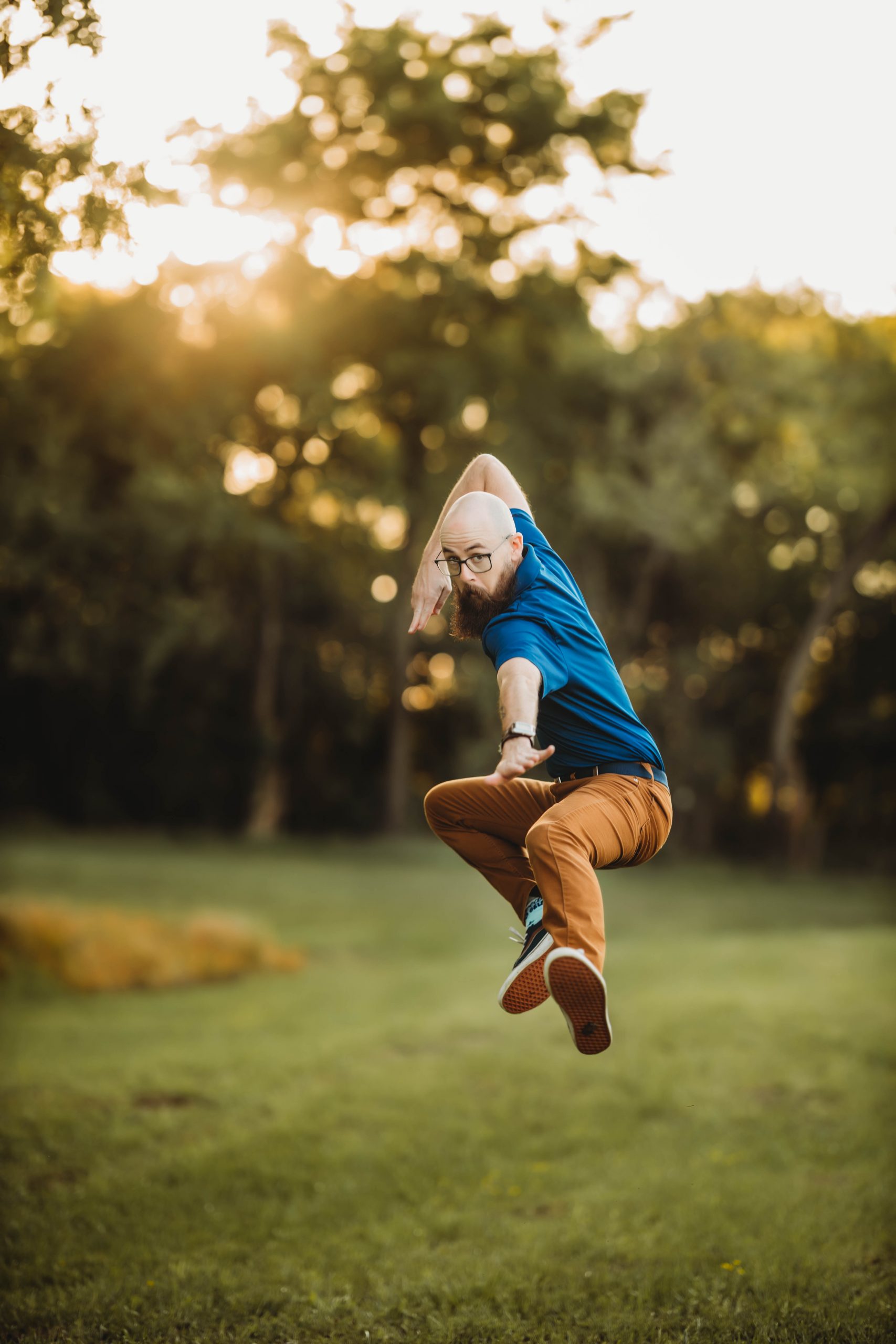 Jeremy kicking in air with sun in background